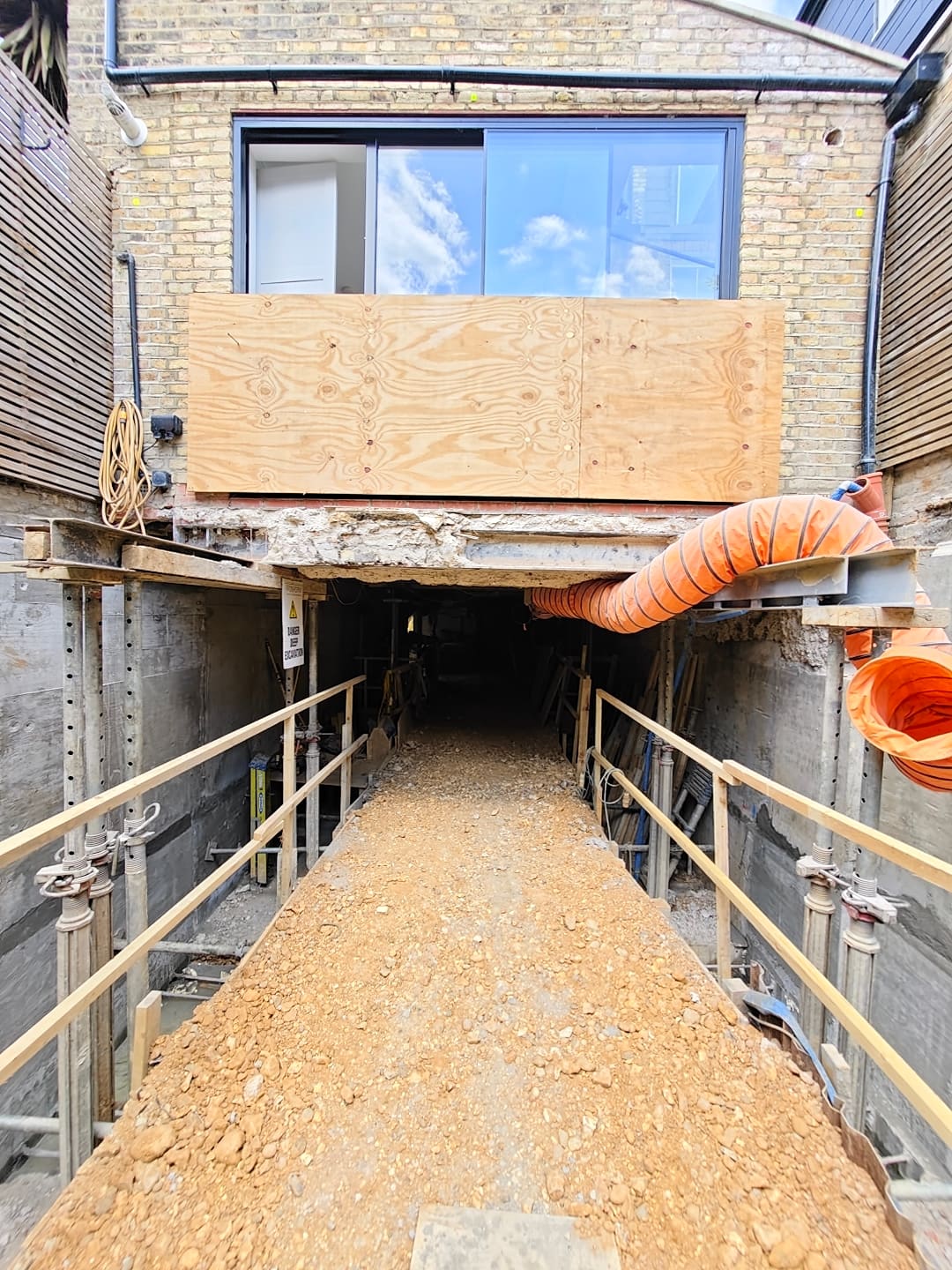 Access ramp into the basement excavation below the rear of the house