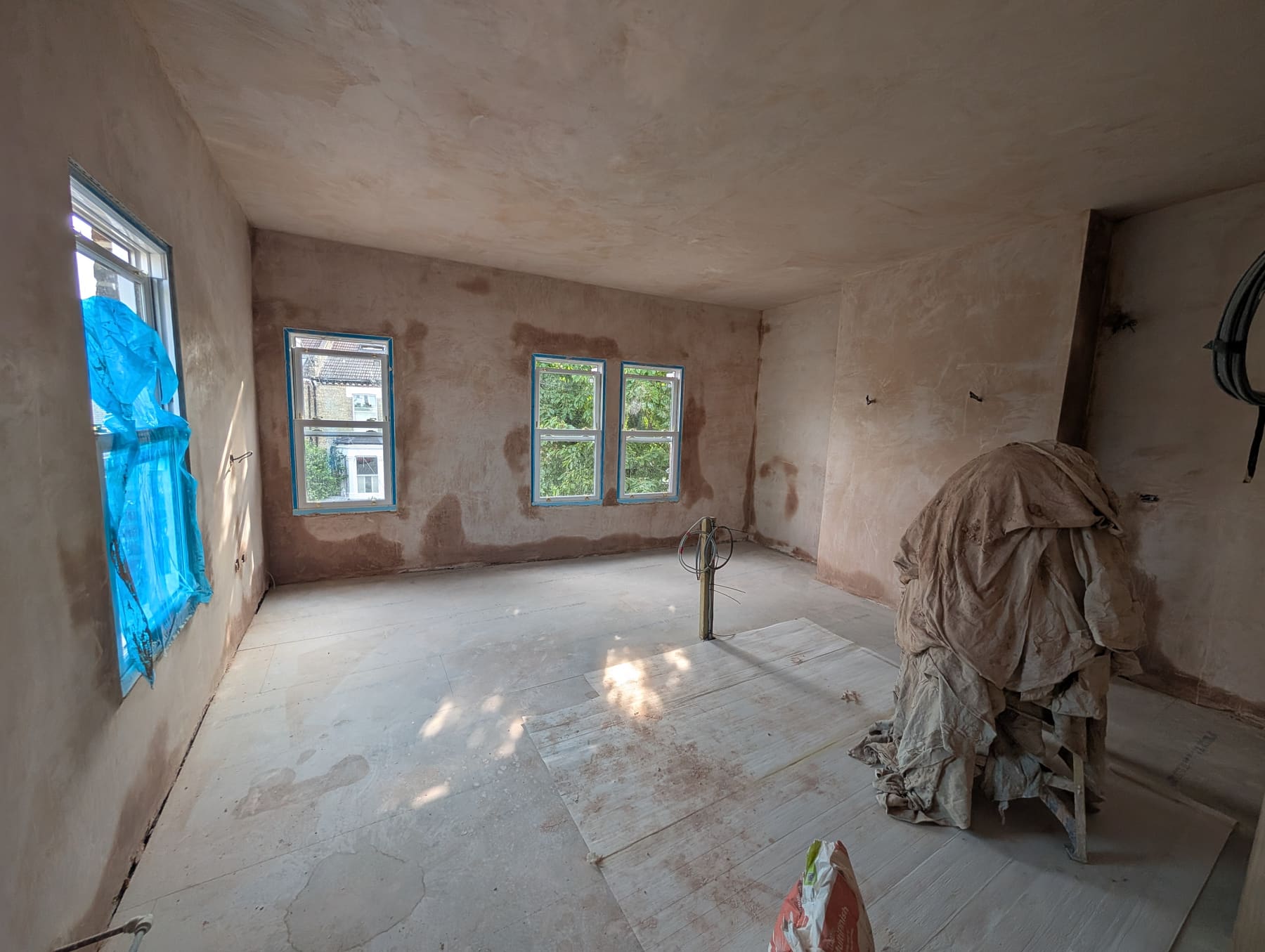 Freshly plastered room with new windows during a whole-house refurbishment